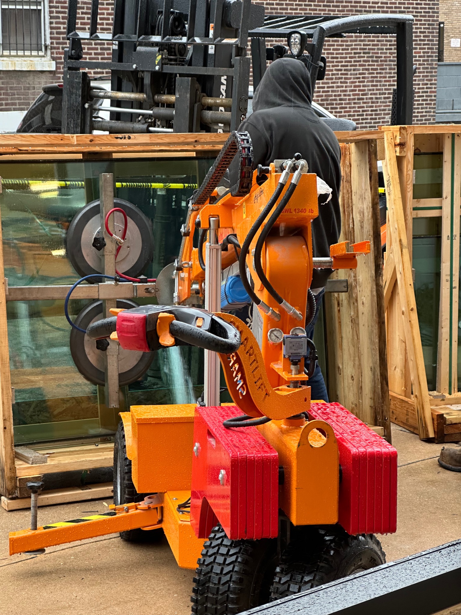 Specialized lifting equipment positioned for the protective glazing installation