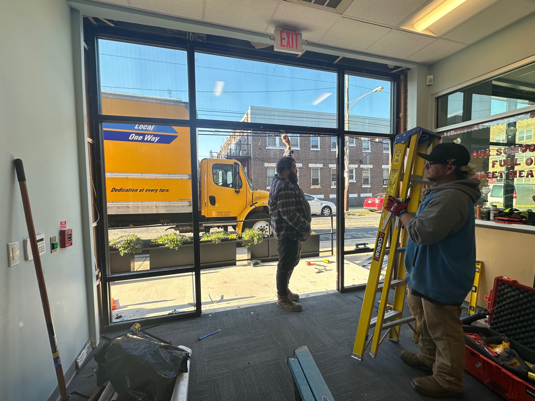 Installation team working on bullet-resistant glazing at a Philadelphia school